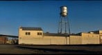 Orland California, water tower, buildings by Railroad tracks. (l12)