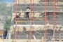 CMHR workers on scafolding