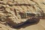 Flat metal, straight sides, sharp angles. Pipe or dohnut to the left of it. Other wierd stuff around this area.  