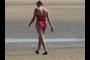 Another Lady Looking for Seashells as She Walks