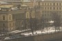 Building facade with snow-covered park