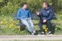 Two boys talking on bench