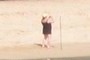 Tourist taking picture of Monk seal
